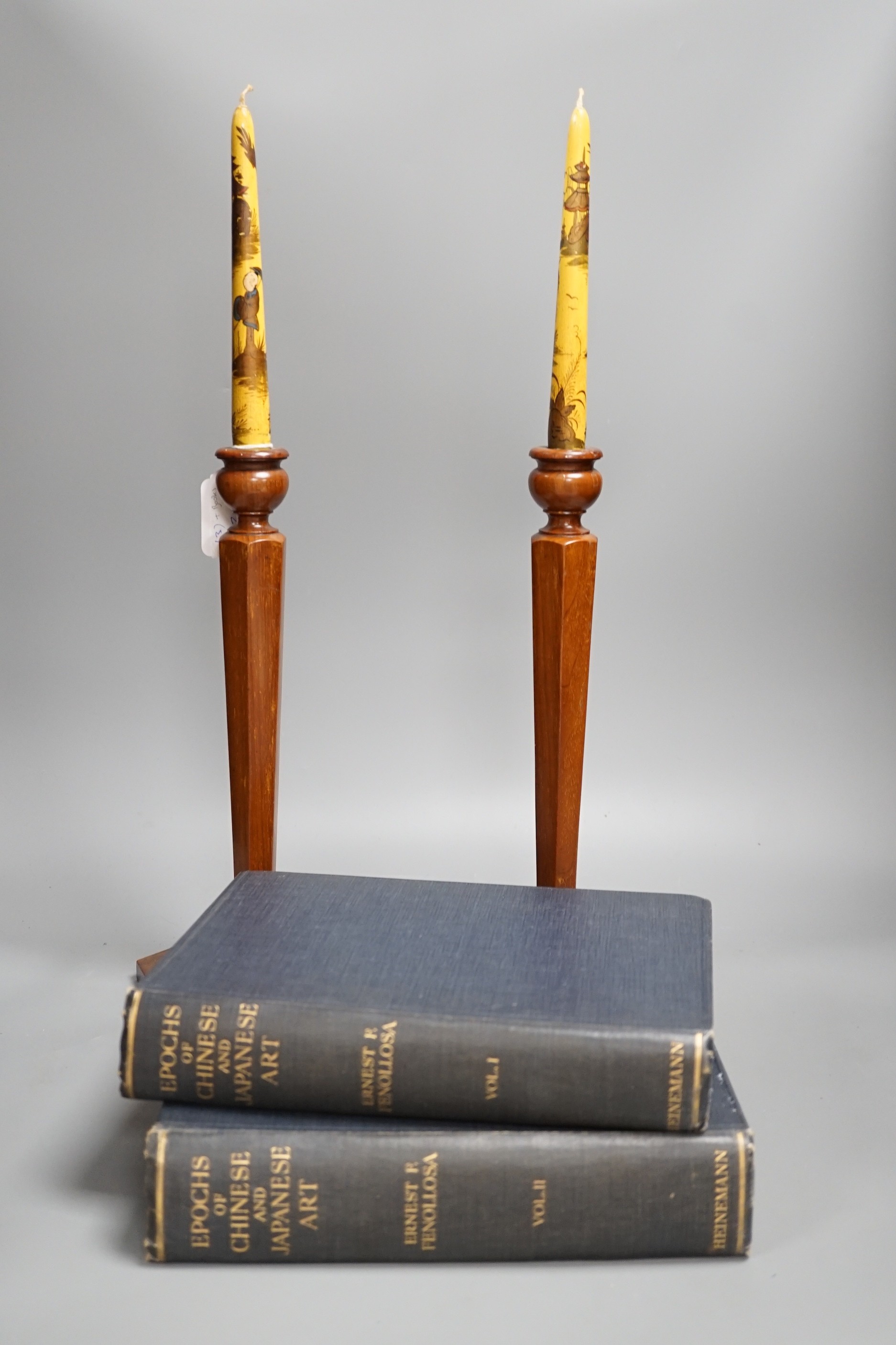 A pair of hexagonal fruitwood candlesticks with chinoiserie faux candles and two volumes on Japanese and Chinese art, candlesticks 53cms high